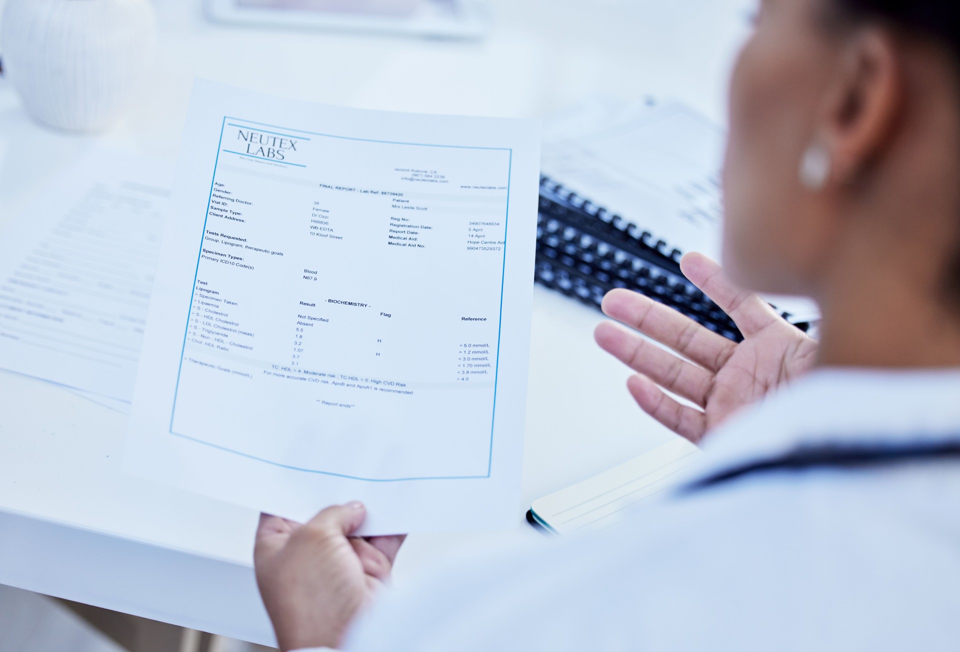 Paperwork, test and doctor with results on document or paper working in office reading prescription in a hospital. Clinic, medicine and medical healthcare professional or worker with insurance